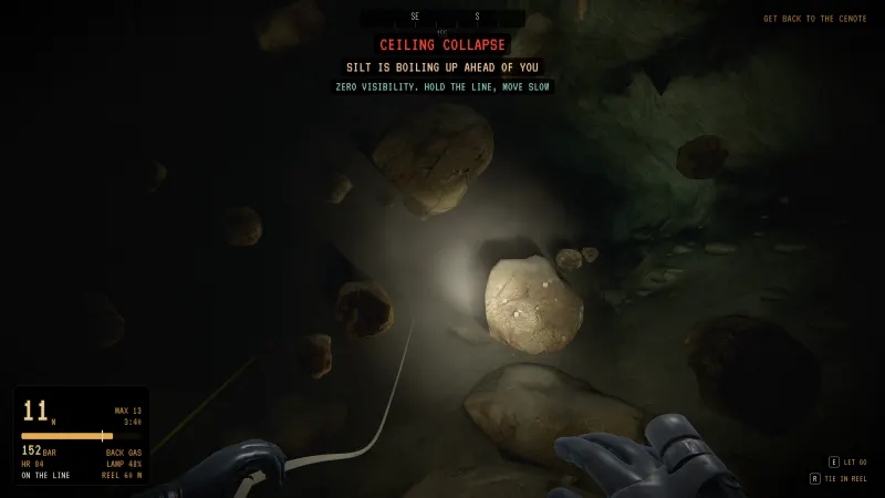 Boulders falling in a ceiling collapse, silt boiling up ahead